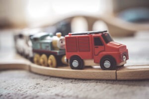 closeup-shot-of-small-toy-car-on-wooden-train-track