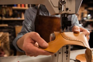 man-cobbler-stitching-leather-parts